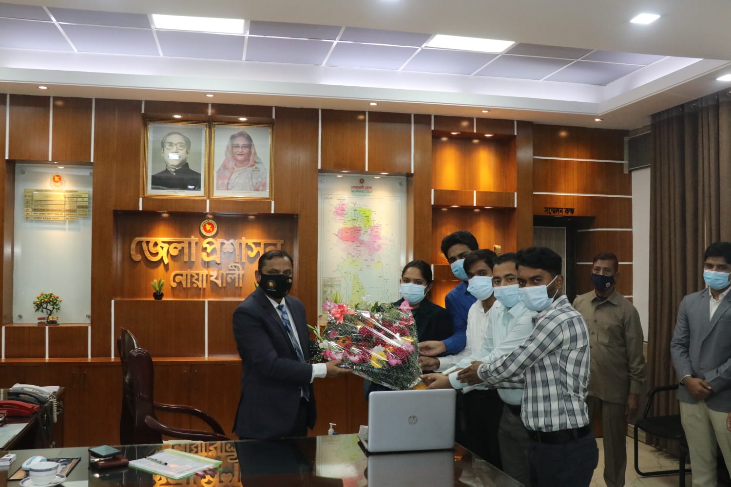 Honorable DC is being welcomed with flowers by the Zila Proshashon School and College  (English version), Noakhali Family 
